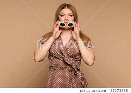 girl wears beige polka dot dress girl wears beige polka dot dress 87175888