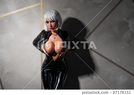 Sexy woman in a blonde wig and latex catsuit. Role-playing games 87176332