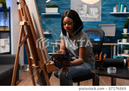 African american student browsing draw inspiration on tablet African american student browsing draw inspiration on tablet 87176869