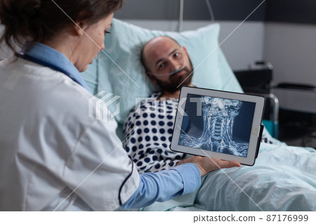 Medic explaining cervical injury to middle aged man with low spo2 saturatio Medic explaining cervical injury to middle aged man with low spo2 saturatio 87176999