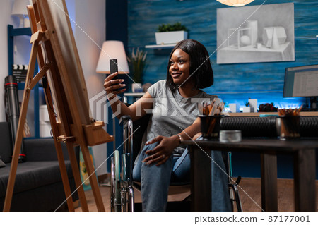 Designer illustration in wheelchair holding phone taking photo Designer illustration in wheelchair holding phone taking photo 87177001