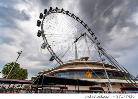 The huge ferris wheel in Singapore, a local landmark, a view from below in cloudy weather 87177436