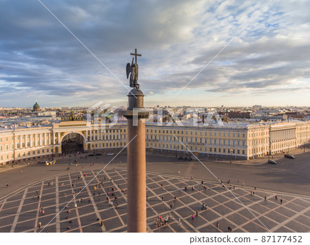 Aerial view of Palace Square and Alexander Column at sunset, a dome of Kazanskiy Cathedral on background, the Winter Palace, walking a little people 87177452