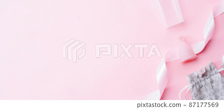 Menstrual period use cup. Pink ribbon with menstrual cup. Menstruation feminine period. Women health concept. Zero waste banner. Top view. 87177569