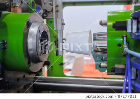 Injection molding machine during work: production of empty plastic pots 87177811