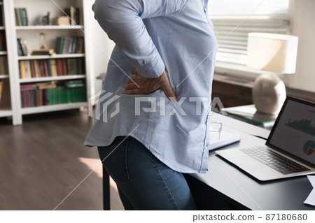 Stressed mature old woman suffering from lower back pain. 87180680