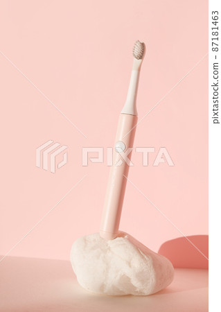 New modern ultrasonic toothbrush. Dental care supplies on white stone on pink pastel background. Oral hygiene, dental and gum health, healthy teeth. Dental products Ultrasonic vibration toothbrush. New modern ultrasonic toothbrush. Dental care supplies on white stone on pink pastel background. Oral hygiene, dental and gum health, healthy teeth. Dental products Ultrasonic vibration toothbrush. 87181463