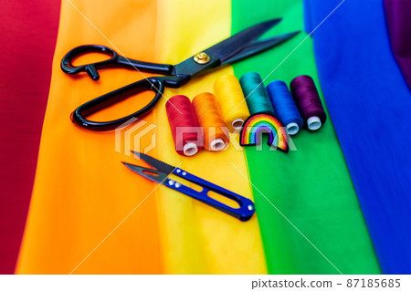 multi-colored pieces of fabric and a threads on the table preparation for the ride parade lgbt 87185685