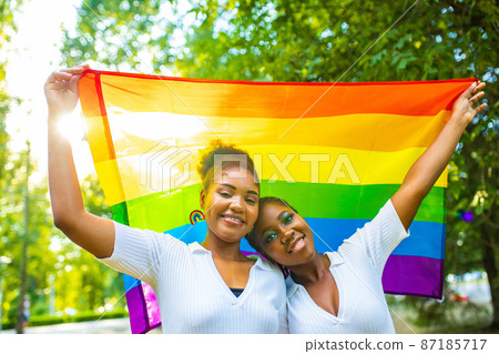 brazilian lesbian couple in white dress spending time together celebrating engagement in summer park outdoor 87185717