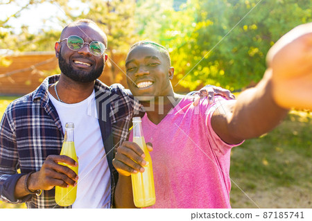 two brazilian men outdoors in summer park at sunset sun light background two brazilian men outdoors in summer park at sunset sun light background 87185741