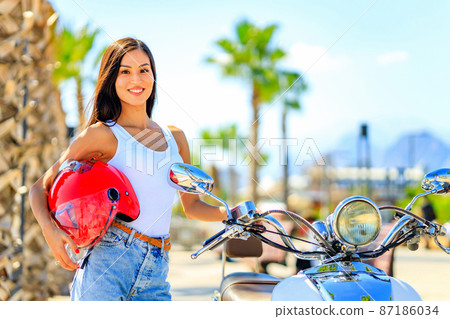 beautiful woman scooter rider drive a bike enjoy her tropicals weekends 87186034