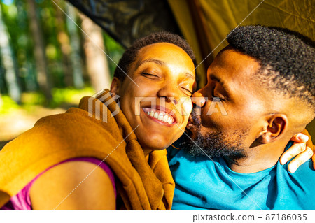 two happy african american people in love spending time outdoors in camp two happy african american people in love spending time outdoors in camp 87186035