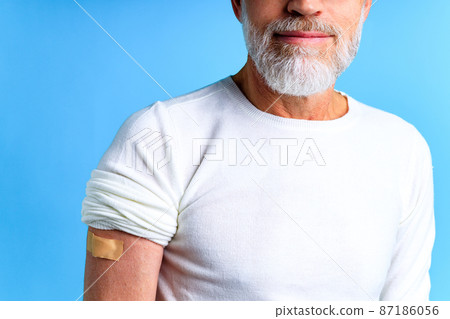 Healthy mature man getting vaccinated immunity blue background studio 87186056