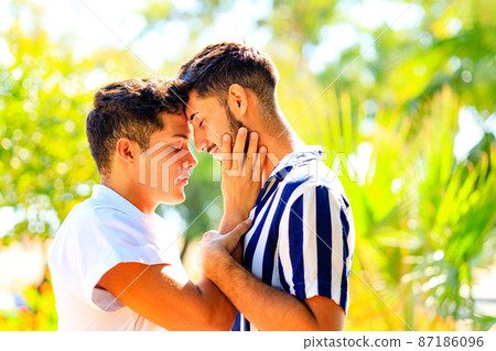 young same sex couple in love outdoors together showing all of feels young same sex couple in love outdoors together showing all of feels 87186096