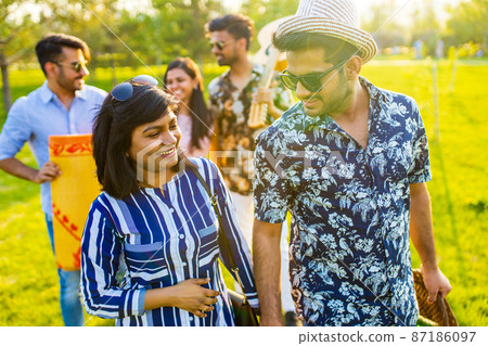 oriental ethnic cheerful friends at pic-nic in sammer park oriental ethnic cheerful friends at pic-nic in sammer park 87186097