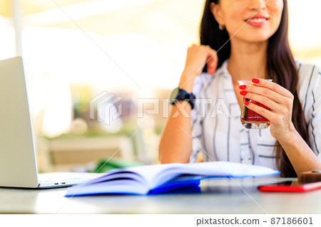 Business asian woman busy working on laptop computer at summer cafe outdoors in tropical beach Business asian woman busy working on laptop computer at summer cafe outdoors in tropical beach 87186601