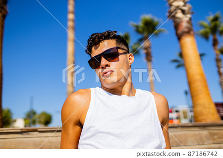 young proud haughty handsome man enjoying sunny day in beach 87186742