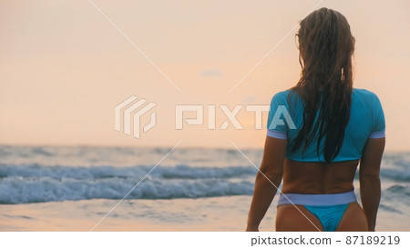 Sexy hot woman sitting on water sea. Girl sit in turquoise swimsuit. Freedom paradise holiday vacation summer beach, seaside landscape concept 87189219