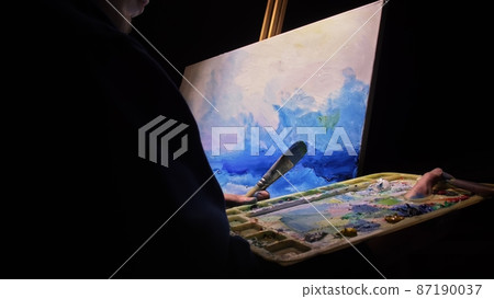 Artist copyist paint seascape with ship in ocean. Craftsman decorator draw as boat sail on blue sea with acrylic oil color. Draw brush, knife palette. Artist copyist paint seascape with ship in ocean. Craftsman decorator draw as boat sail on blue sea with acrylic oil color. Draw brush, knife palette. 87190037