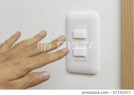 The hand of a man who seems to touch the outlet 87191071