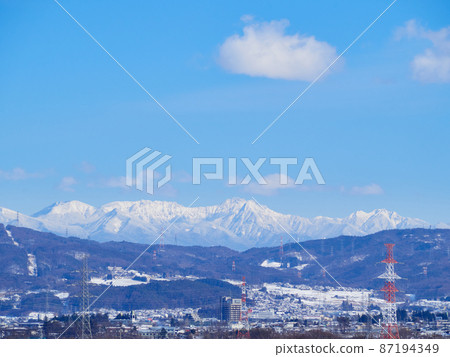 February (Winter) Yatsugatake (Yokodake, Akadake, Gongendake) and Shiojiri cityscape Shiojiri city, Nagano prefecture 87194349
