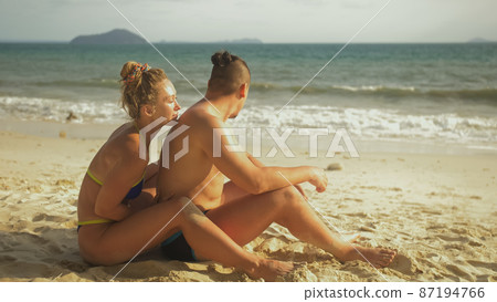 Hot sexy loving couple having sun block. Woman to put sunscreen 87194766