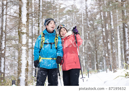 Couple enjoying snowshoes Couple enjoying snowshoes 87195632