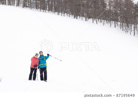 Couple enjoying the snowy mountains 87195649