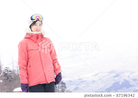 A woman enjoying a snowy mountain A woman enjoying a snowy mountain 87196342