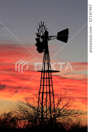 Kansas colorful Sunset with clouds and trees out in the country that's bright and colorful. Kansas colorful Sunset with clouds and trees out in the country that's bright and colorful. 87197467