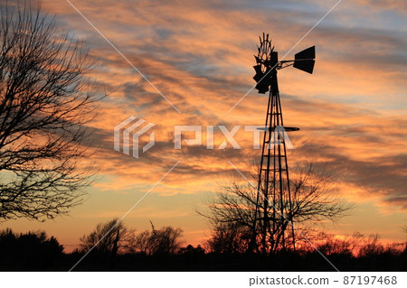 Kansas colorful Sunset with clouds and trees out in the country that's bright and colorful. Kansas colorful Sunset with clouds and trees out in the country that's bright and colorful. 87197468