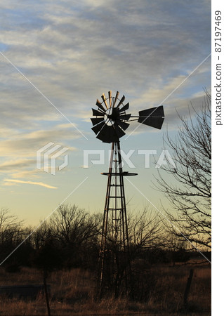 Kansas colorful Sunset with clouds and trees out in the country that's bright and colorful. Kansas colorful Sunset with clouds and trees out in the country that's bright and colorful. 87197469