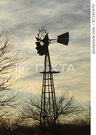 Kansas colorful Sunset with clouds and trees out in the country that's bright and colorful. 87197470