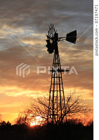 Kansas colorful Sunset with clouds and trees out in the country that's bright and colorful. Kansas colorful Sunset with clouds and trees out in the country that's bright and colorful. 87197471
