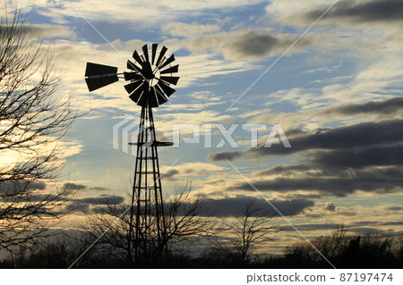 Kansas colorful Sunset with clouds and trees out in the country that's bright and colorful. Kansas colorful Sunset with clouds and trees out in the country that's bright and colorful. 87197474