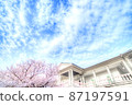 Western-style building with cherry blossom-colored railings and garden in full bloom A refreshing cloud sky with cherry blossoms 87197591