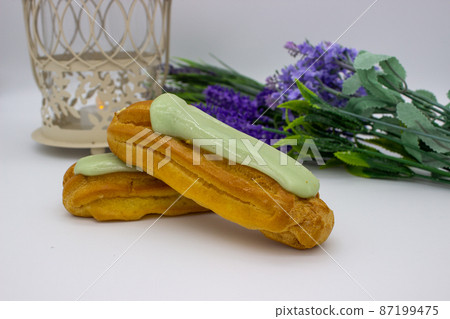 Lovely delicious eclairs with pistachio filling Lovely delicious eclairs with pistachio filling 87199475