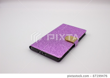 Phone in pink case on gray background Phone in pink case on gray background 87199476