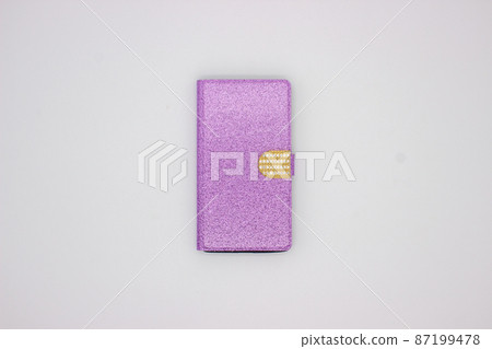 Phone in pink case on gray background Phone in pink case on gray background 87199478