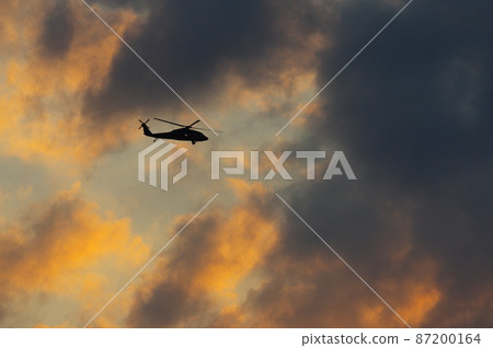 Helicopter flying in the evening Helicopter flying in the evening 87200164