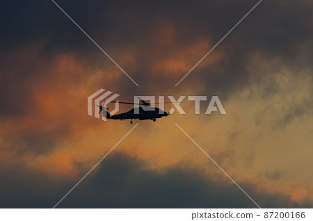Helicopter flying in the evening Helicopter flying in the evening 87200166