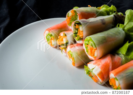 Fresh vegetable salad roll in noodle tube on dish isolated on white background 87200187