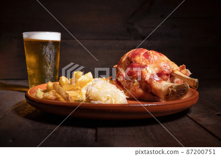 Traditional German cuisine roasted ham hock, sauerkraut and Beer, Oktoberfest background. 87200751