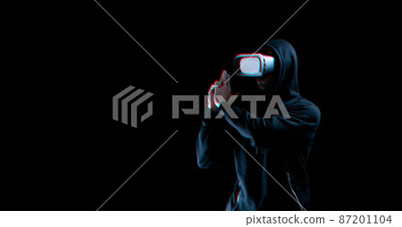 Vr glasses virtual reality. Blured young man in digital headset for virtual reality technology on dark background with glitch effect. Amazing technology, online game, entertainment. 87201104