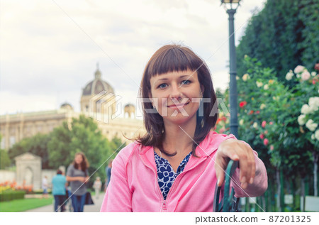 Close-up portrait of young beautiful caucasian girl looking at camera and smile in Volksgarten garden park Close-up portrait of young beautiful caucasian girl looking at camera and smile in Volksgarten garden park 87201325