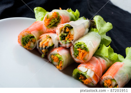 Fresh vegetable salad roll in noodle tube on dish isolated on white background Asian street food 87201951