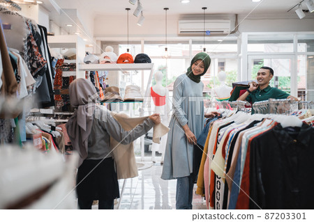 muslim family shopping together at the mall buying some new clothes 87203301