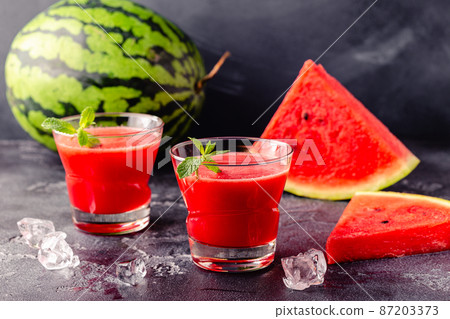 Fresh tasty delicious watermelon juice on a dark background 87203373