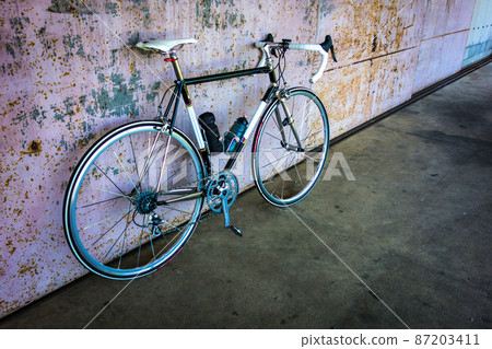 Warehouse iron door and black road bike Warehouse iron door and black road bike 87203411