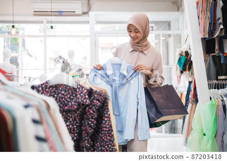 asian muslim woman shopping new clothes before eid mubarak asian muslim woman shopping new clothes before eid mubarak 87203418